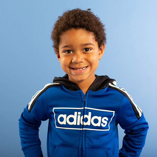 Boy in blue adidas sweatshirt